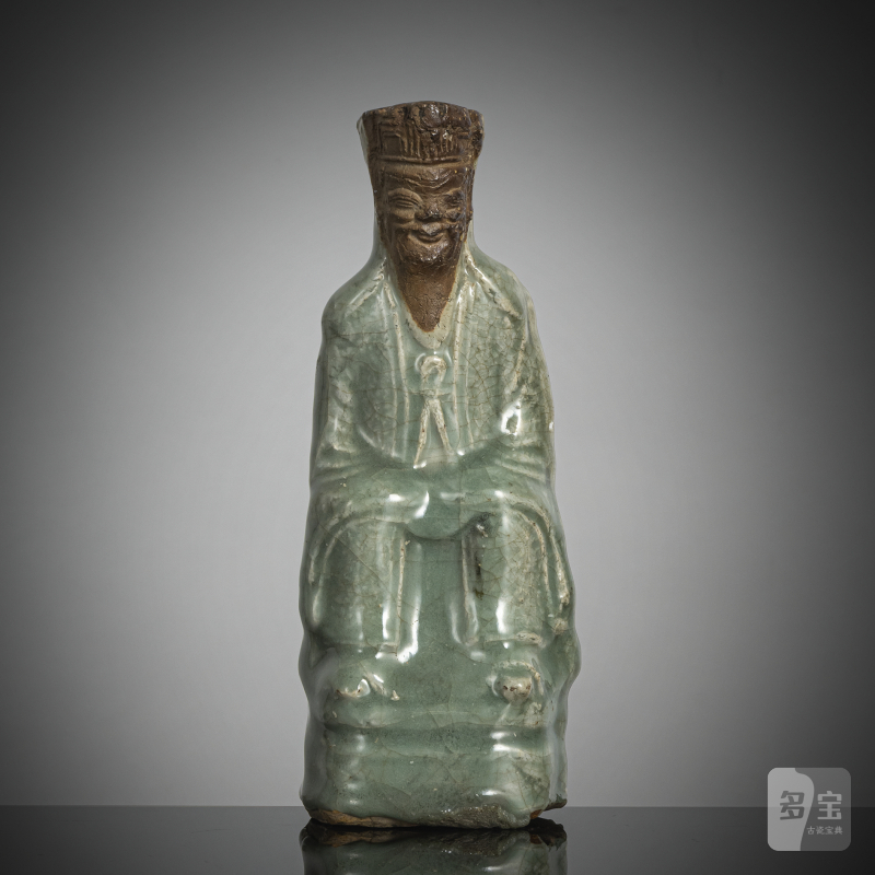 Longquan figure of a dignitary with celadon glaze